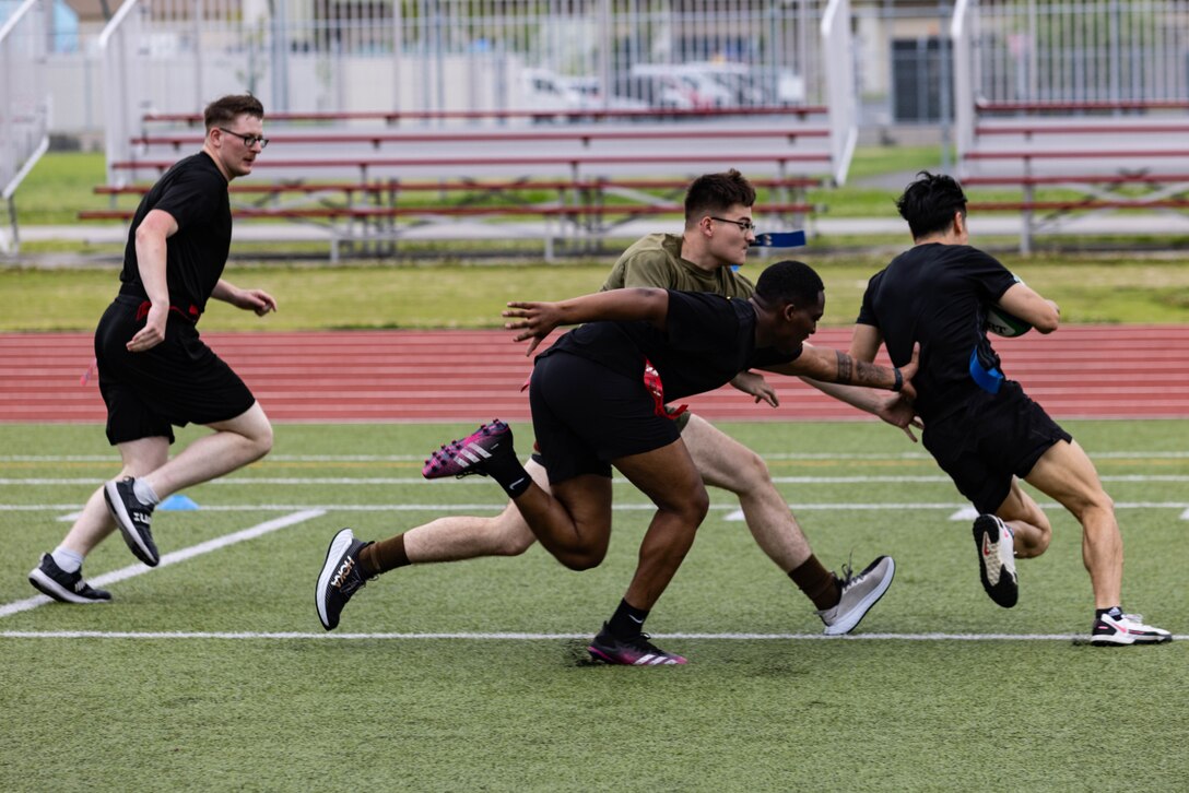 A member of the Japan Maritime Self-Defense Force attempts to avoid opposing players during a rugby match between Marines and members of the Japan Self-Defense Force at Marine Corps Air Station Iwakuni, Japan, June 25, 2024. The rugby match was held as a way to bring Marines and JSDF members from MCAS Iwakuni together to build camaraderie through friendly competition. (U.S. Marine Corps photo by Lance Cpl. Dahkareo Pritchett)