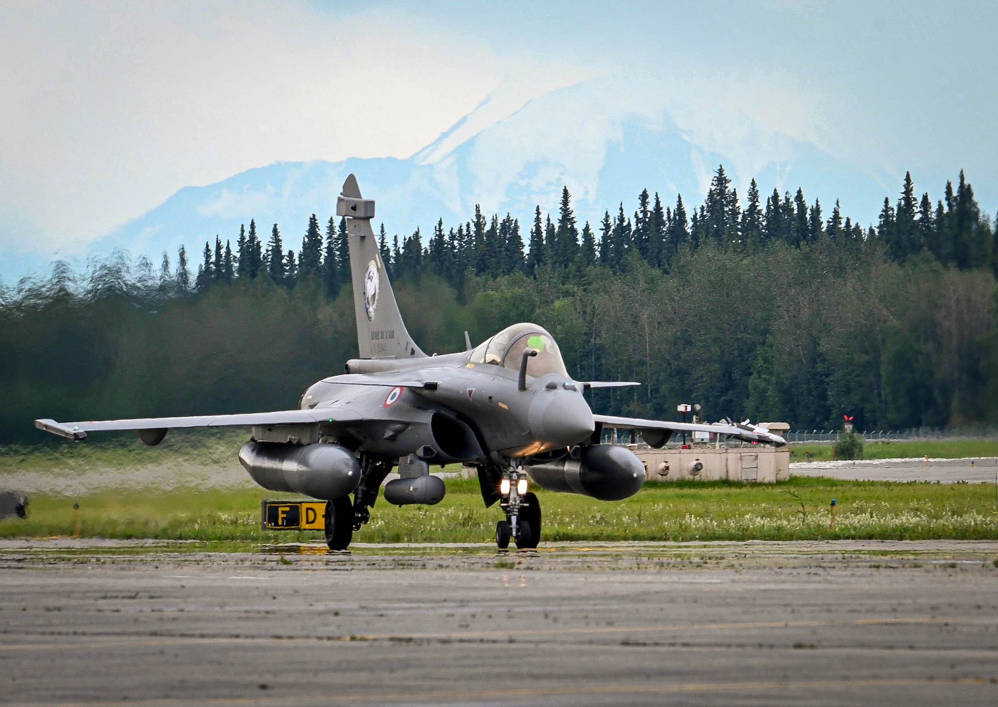 A French Rafale fighter jet taxis on the runway.