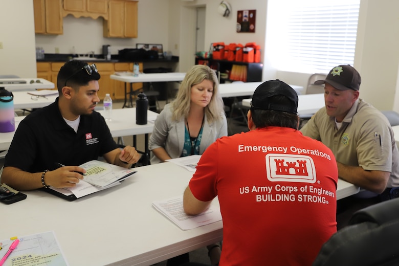 A small group, led by a Los Angeles District emergency manager, rehearses emergency response tactics to a natural disaster scenario during an emergency tabletop training exercise, or TTX, June 25 at Panaca Fire Station in Lincoln County, Nevada. The TTX is designed to review, practice and assess federal and nonfederal partners’ response to catastrophic disaster scenarios in Lincoln and Clark County, Nevada. The U.S. Army Corps of Engineers’ Emergency Management Team provides engineering services to respond to national and natural disasters to minimize damage and help in recovery efforts.