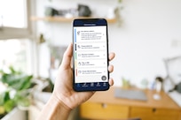 Image of hand holding smartphone showing the options available in the Express Scripts Pharmacy mobile app.