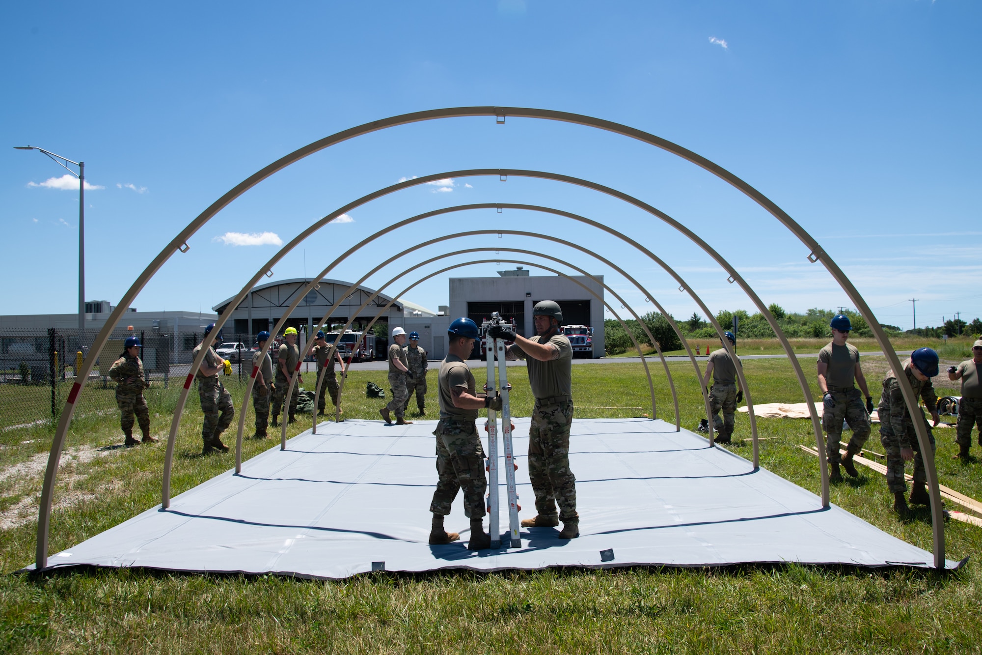 Airmen assigned to the 171st Civil Engineer Squadron in Pittsburgh, Pennsylvania, and the 177th Civil Engineer Squadron erect Disaster Relief Beddown System tents as part of the Piney Devil training exercise, June 8, 2024, on Atlantic City Air National Guard Base, Egg Harbor Township.