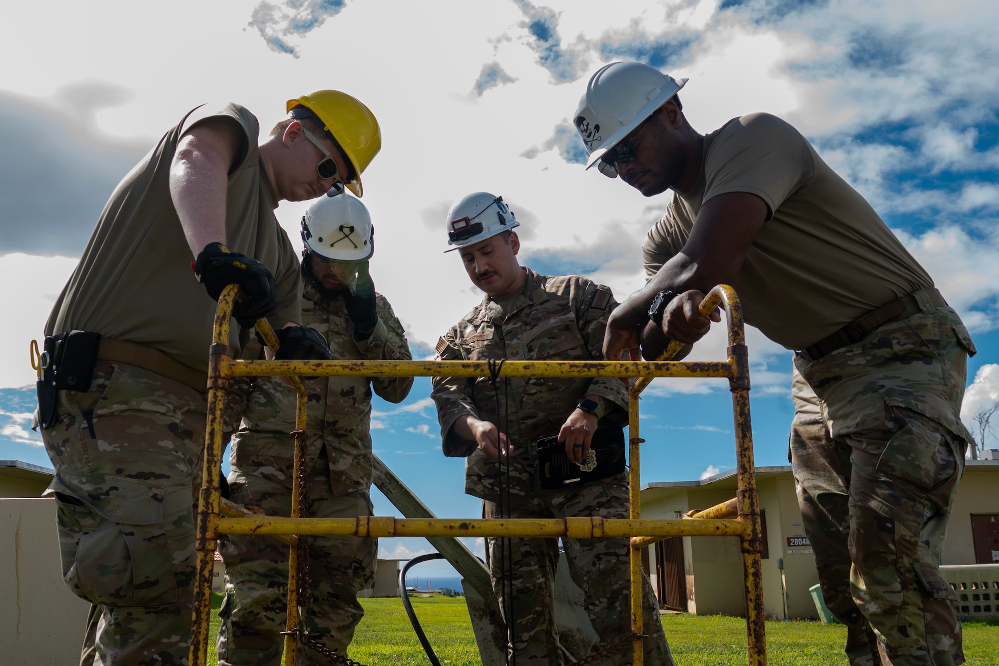 U.S. Air Force members of the 85th Engineering Installation Squadron, Keesler Air Force Base, survey a manhole at Andersen Air Force Base, Guam, July 10, 2024.