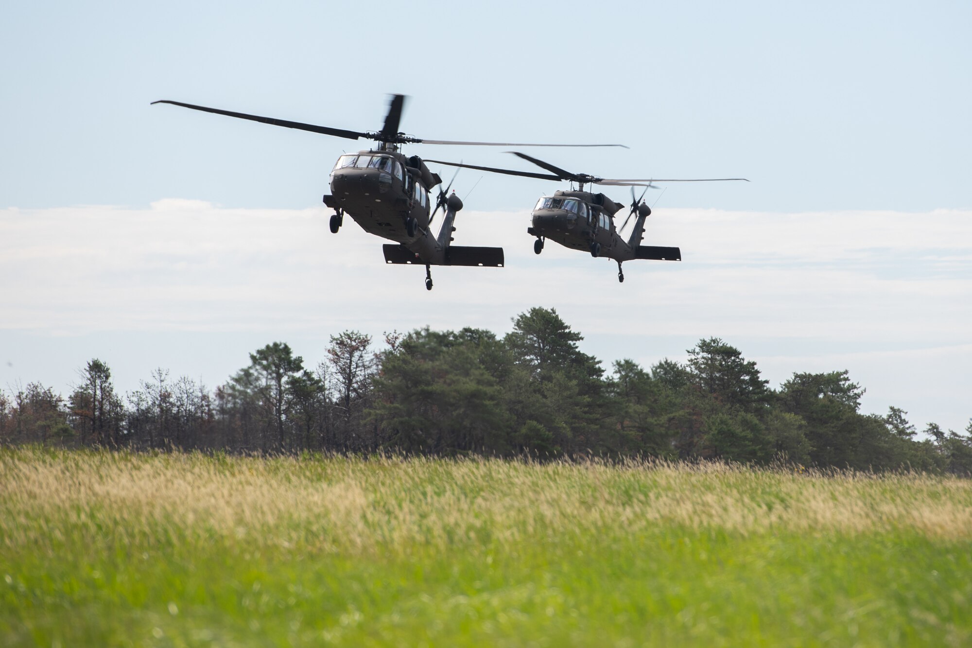 Airmen assigned to the 171st Civil Engineer Squadron and the 177th Civil Engineer Squadron arrive aboard UH-60 Black Hawk helicopters to perform land navigation and simulated combat training exercises as part of the Piney Devil training exercise on June 9, 2024, at Warren Grove Range, New Jersey.