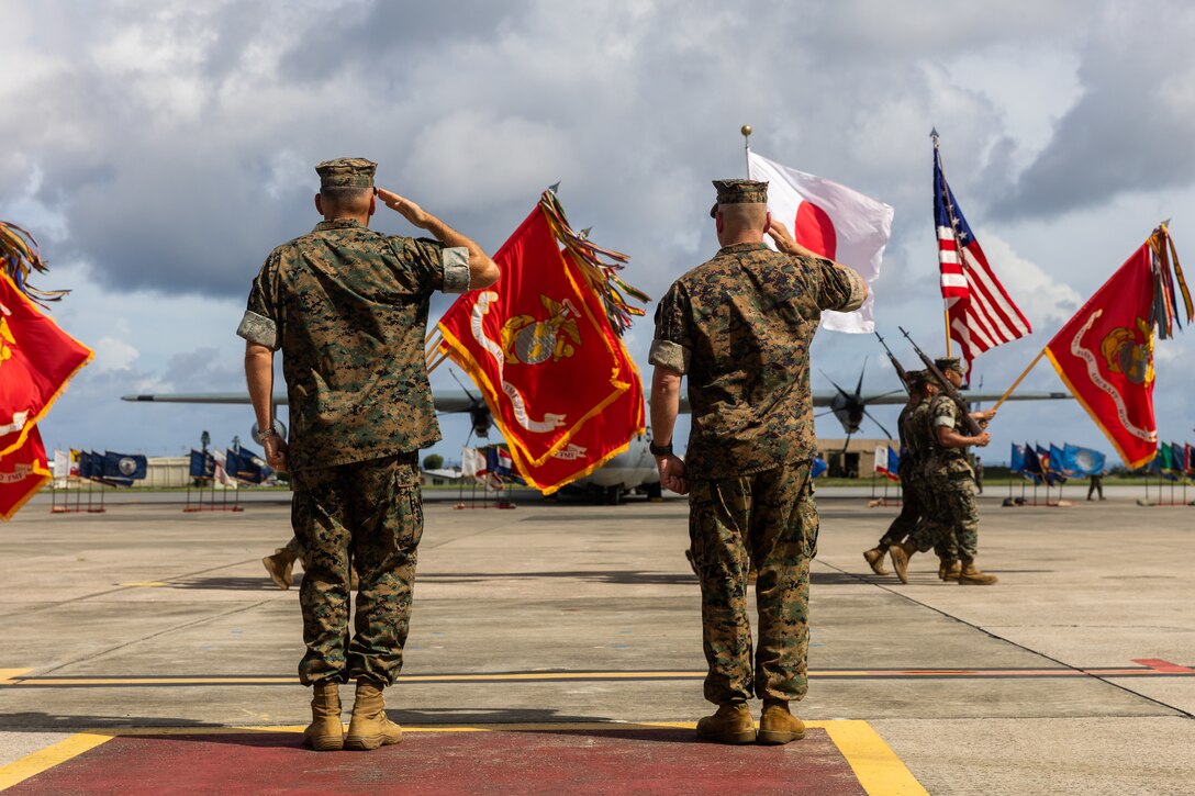 U.S. Marine Corps Maj. Gen. Marcus B. Annibale, right, the commanding general of 1st Marine Aircraft Wing, and Maj. Gen. Eric E. Austin, the outgoing commanding general, salute the colors during a change of command ceremony at Marine Corps Air Station Futenma, Okinawa, Japan, July 12, 2024. 1st MAW is the aviation combat element of III Marine Expeditionary Force. Its mission is to conduct air operations in support of the Fleet Marine Forces to include offensive air support, anti-air support, assault support, aerial reconnaissance, electronic warfare, and control of aircraft and missiles. (U.S. Marine Corps photo by Cpl. Kyle Chan)