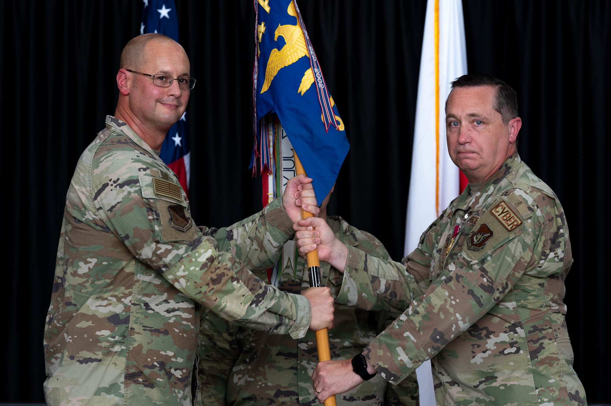 airmen saluting, honoring ceremony of change of leadership