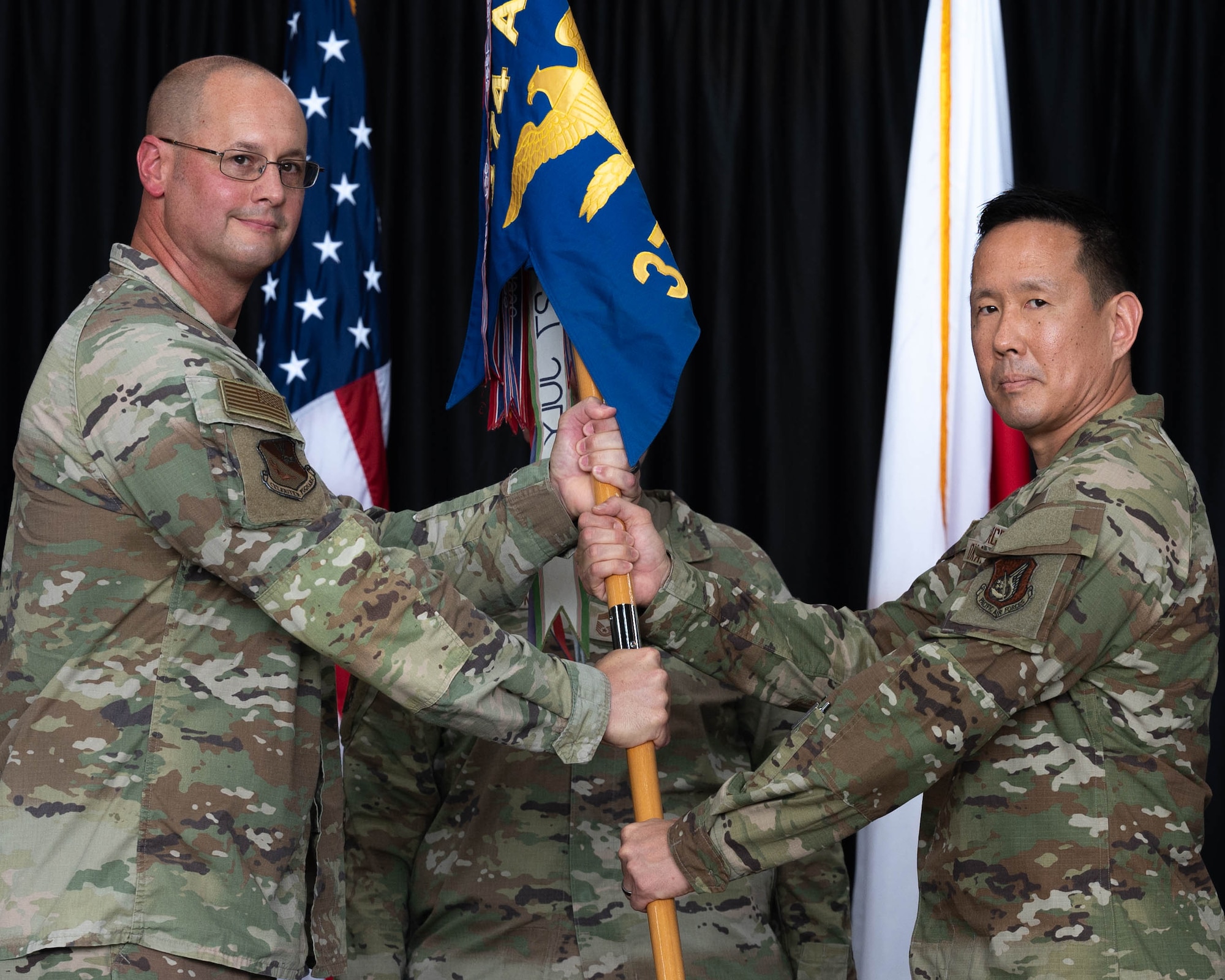 airmen saluting, honoring ceremony of change of leadership