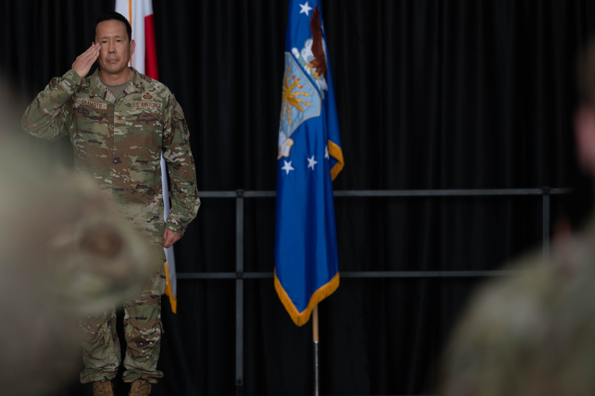 airmen saluting, honoring ceremony of change of leadership