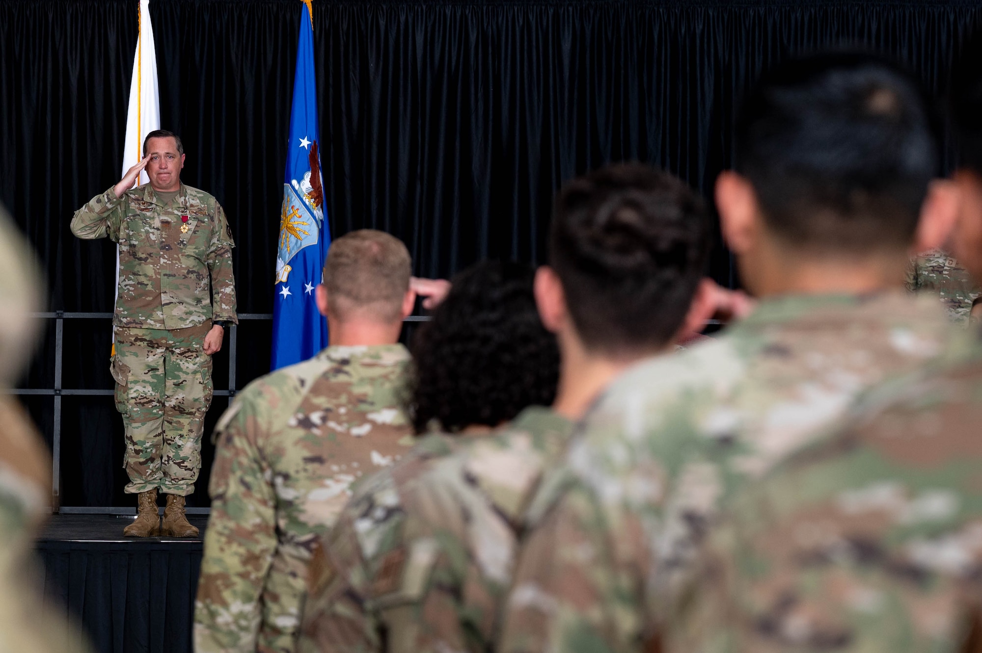 airmen saluting, honoring ceremony of change of leadership