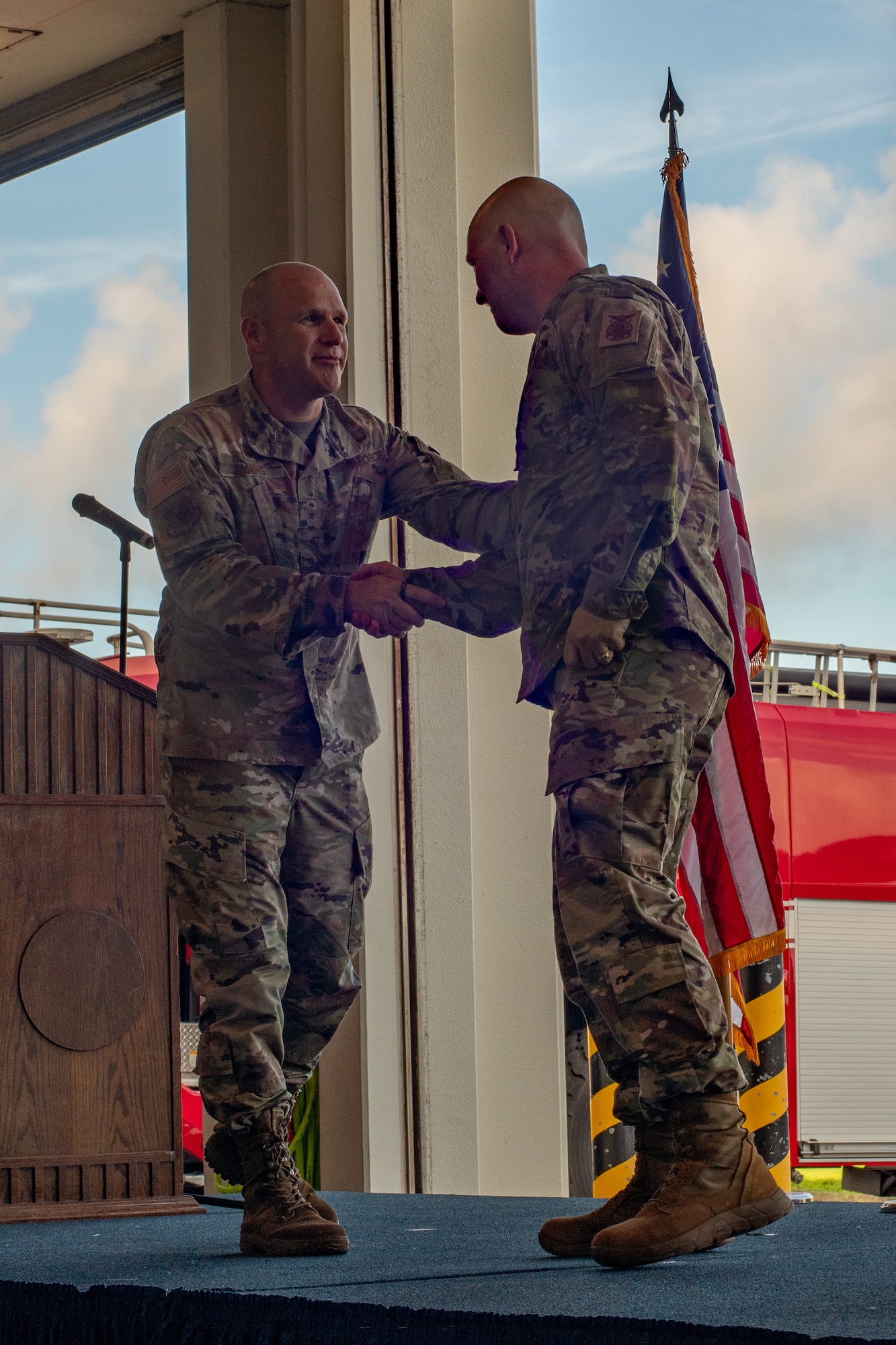 Military member shakes hands with other military member