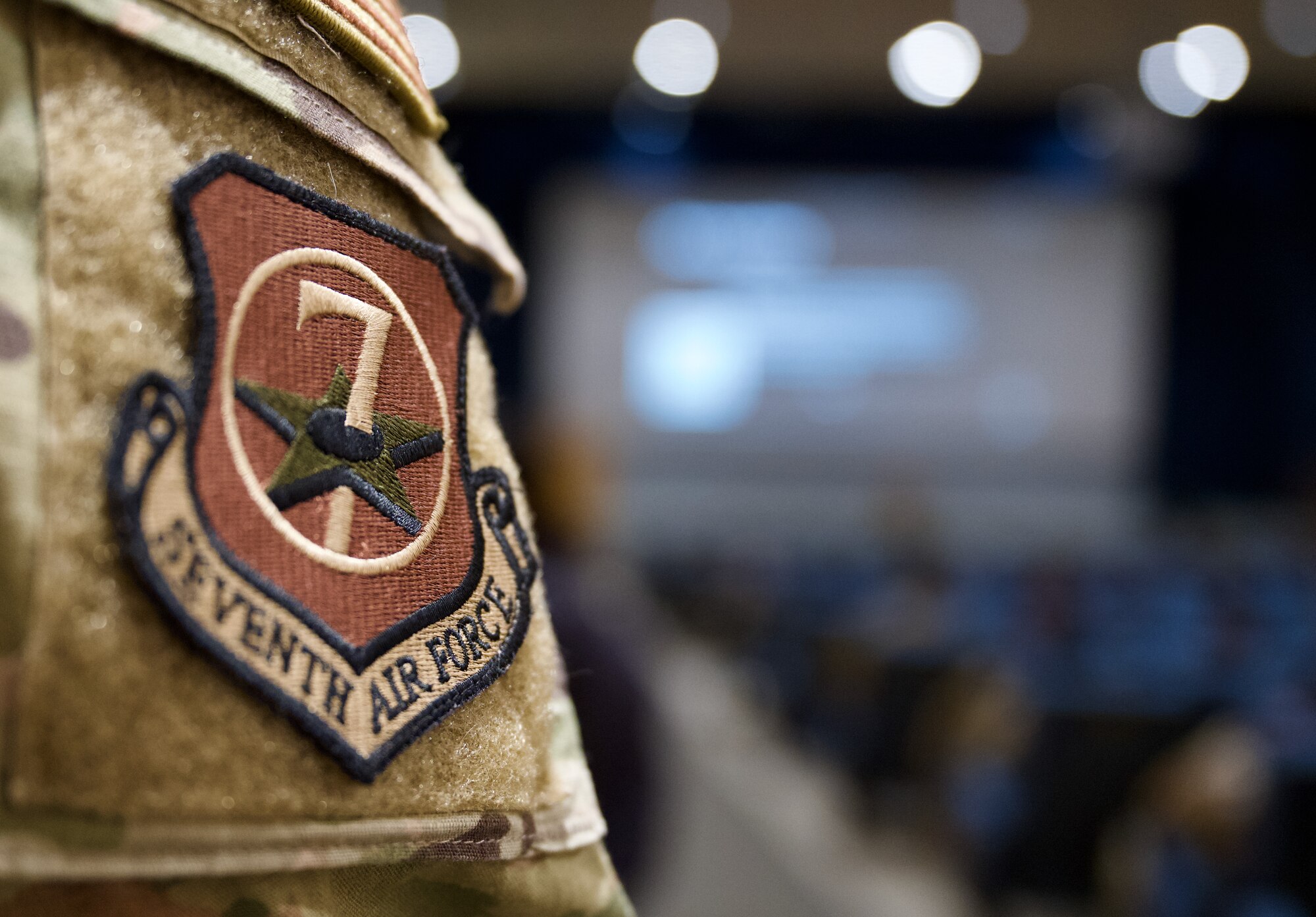 n Airman assigned to the 7th Air Force listens as Chief Master Sgt. Jeremiah Ross, 7th AF command chief, addresses members of the Wolf Pack during a noncommissioned officer all-call