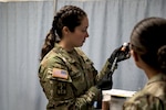 1st Lt. Jennifer Vanden Busch, the Joint Readiness Training Center Aid Station Rear operations officer, prepares a syringe June 13, 2024, during a training rotation for the Wisconsin Army National Guard’s 32nd “Red Arrow” Infantry Brigade Combat Team. She was among the medics, nurses and physicians from the Wisconsin National Guard and surrounding states who responded to a call for volunteers to staff the JRTC clinic.
