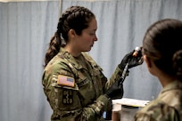 1st Lt. Jennifer Vanden Busch, the Joint Readiness Training Center Aid Station Rear operations officer, prepares a syringe June 13, 2024, during a training rotation for the Wisconsin Army National Guard’s 32nd “Red Arrow” Infantry Brigade Combat Team. She was among the medics, nurses and physicians from the Wisconsin National Guard and surrounding states who responded to a call for volunteers to staff the JRTC clinic.