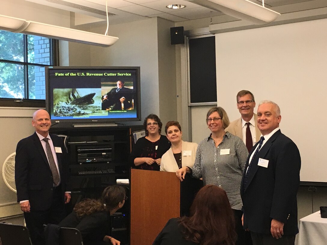 The USCG Historian's Office Team at the 2023 McMullen Naval History Symposium held at U.S. Naval Academy in September, 2017.  Left to right: Scott Price (Chief Historian); Nora Chidlow (Archive Technician); Beth Crumley (Assistant Historian); Arlyn Danielson (Curator); Dr. Bill Thiesen (LANTAREA Historian) & Chris Havern (NHHC Historian & former Assistant CG Historian).