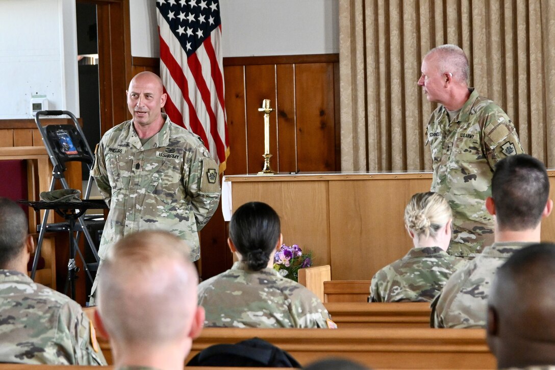 Pennsylvania Adjutant General Maj Gen Mark Schindler, right, and U.S. Army Command Sgt Maj. Shawn Phillips, command senior enlisted leader, speak at a conference for chpalains at Memorial Chapel at Fort Indiantown Gap July 2, 2024. Military Chaplains provide motivation, support, spiritual guidance, and help spread faith to all service members. (U.S. Army National Guard photo by Spc. Jessica Barb)