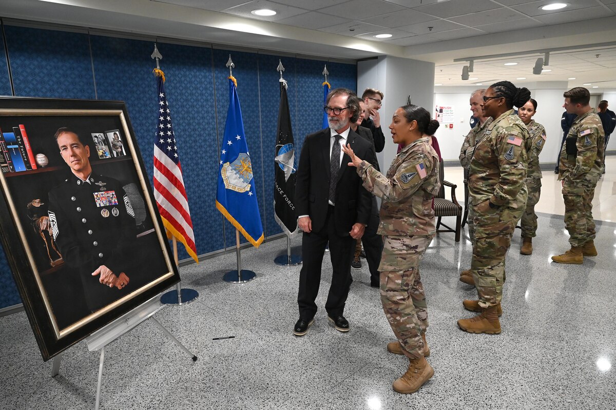 Former Chief Master Sgt. of the Space Force Roger A. Towberman and other Guardians view his portrait at the Pentagon, Arlington, Va. July 9, 2024. The portrait unveiling marks one of many historic firsts for a military service that was established less than five years prior, Dec. 20, 2019. (U.S. Air Force photo by Chad Trujillo)