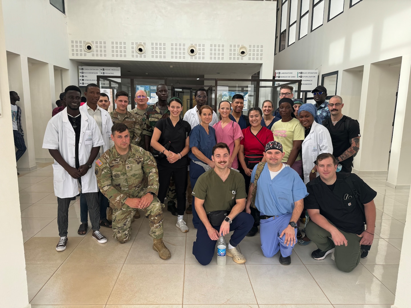 U.S. Soldiers and Airmen with the Vermont and New Hampshire National Guard pose for a photo with the medical staff at the Kedougou regional hospital in Kedougou, Senegal.