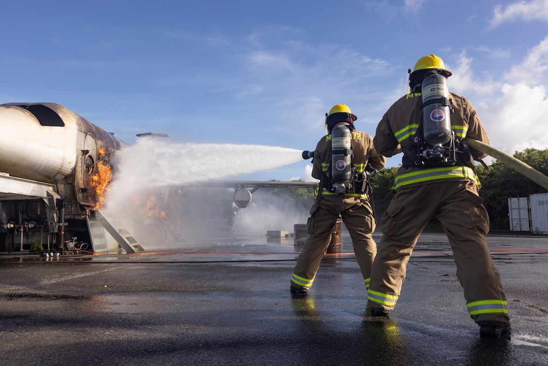 U.S. Marines with Marine Wing Support Squadron 172 extinguish a controlled fire during burn training on Kadena Air Base, Okinawa, Japan, July 10, 2024. MWSS-172, Tennessee Air National Guard, and 18th Civil Engineer Squadron conducted joint training to promote inter-service camaraderie and morale, as well as boost mission readiness and cross-training capabilities.