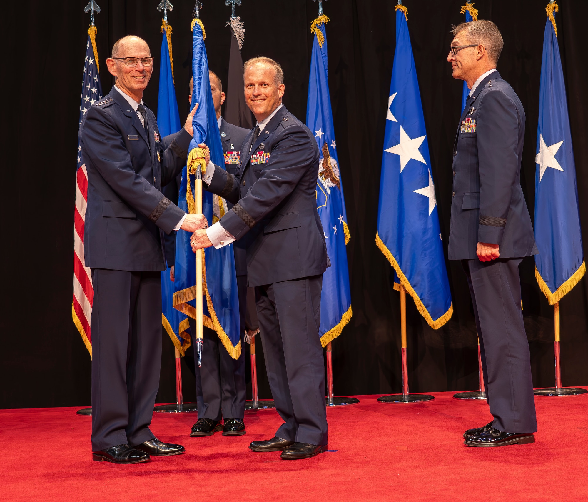 Brig. Gen Jason E. Bartolomei, middle, assumes command of the Air Force Research Laboratory, or AFRL, in a change of command ceremony at the National Museum of the United States Air Force in Dayton, Ohio, July 10, 2024 from Gen. Duke Z. Richardson, commander, Air Force Materiel Command, left, as outgoing AFRL Commander Maj. Gen. Scott A. Cain, right, observes. As AFRL’s newest commander, Bartolomei now oversees more than 12,500 Airmen, Space Force Guardians, Pentagon civilians and contractors. Prior to assuming command of AFRL, Bartolomei served as the Program Executive Officer for Weapons and Director of the Armament Directorate at the Air Force Life Cycle Management Center, or AFLCMC, at Eglin Air Force Base, Florida. He took the reins from Cain, who served as AFRL’s commander since June 2023. (U.S. Air Force photo / Keith Lewis)
