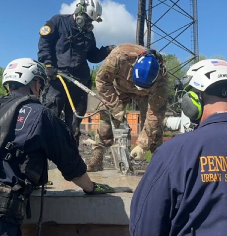 Pennsylvania Air National Guardsman Tech. Sgt. Scott Frederick with the 171st Air Refueling Wing Fire and Emergency Services Flight operates the DS11 hydraulic concrete chainsaw while receiving training from members of Pennsylvania Strike Team 1, at the Allegheny County Fire Academy, May 8, 2024. The partnership between the 171st and PA ST1 allows for shared resources and expertise, and provides a comprehensive training environment that benefits participants and the communities they serve. (courtesy photo)