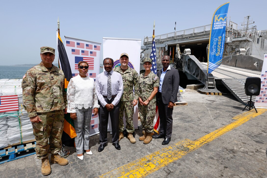 Lt. Col. Luis Preciado, Defense Attache to Jamaica; Dr. Nicole Dawkins-Wright, Director of Emergency, Disaster Management, and Special Services at the Jamaica Ministry of Health & Wellness; N. Nick Perry, U.S. Ambassador to Jamaica; Lt. Cmdr. Zachary Smith, Continuing Promise 2024 Mission Commander; Lt. Christina Leyton, U.S. Embassy Security Cooperation Office Navy Section Lead; and Mark Williams, CEO of Kingston Wharves Limited, pose for a photo in front of U.S. Department of Defense Denton Program donations provided to the government of Jamaica as part of Continuing Promise 2024. Continuing Promise 2024 marks the 14th mission to the region since 2007, which aims to foster goodwill, strengthen existing partnerships, and encourage the establishment of new partnerships among countries’ non-government organizations, and international organizations