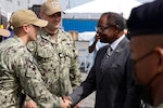 Lt. Cmdr. Zachary Smith, Continuing Promise 2024 Mission Commander, and Lt. Daniel Ehrlich, Continuing Promise 2024 Public Affairs Officer, greet U.S. Ambassador to Jamaica N. Nick Perry prior to his visit and tour of Spearhead-class expeditionary fast transport ship USNS Burlington (T-EPF 10) at Kingston Wharves.