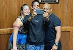 (Center) Christian Castro, Navy applicant, poses for a photo with his parents following his Oath of Enlistment at Tampa MEPS. USMEPCOM recently released policy allowing two guests per applicant about to ship to basic training, as well as National Guard and Reserve component applicants.