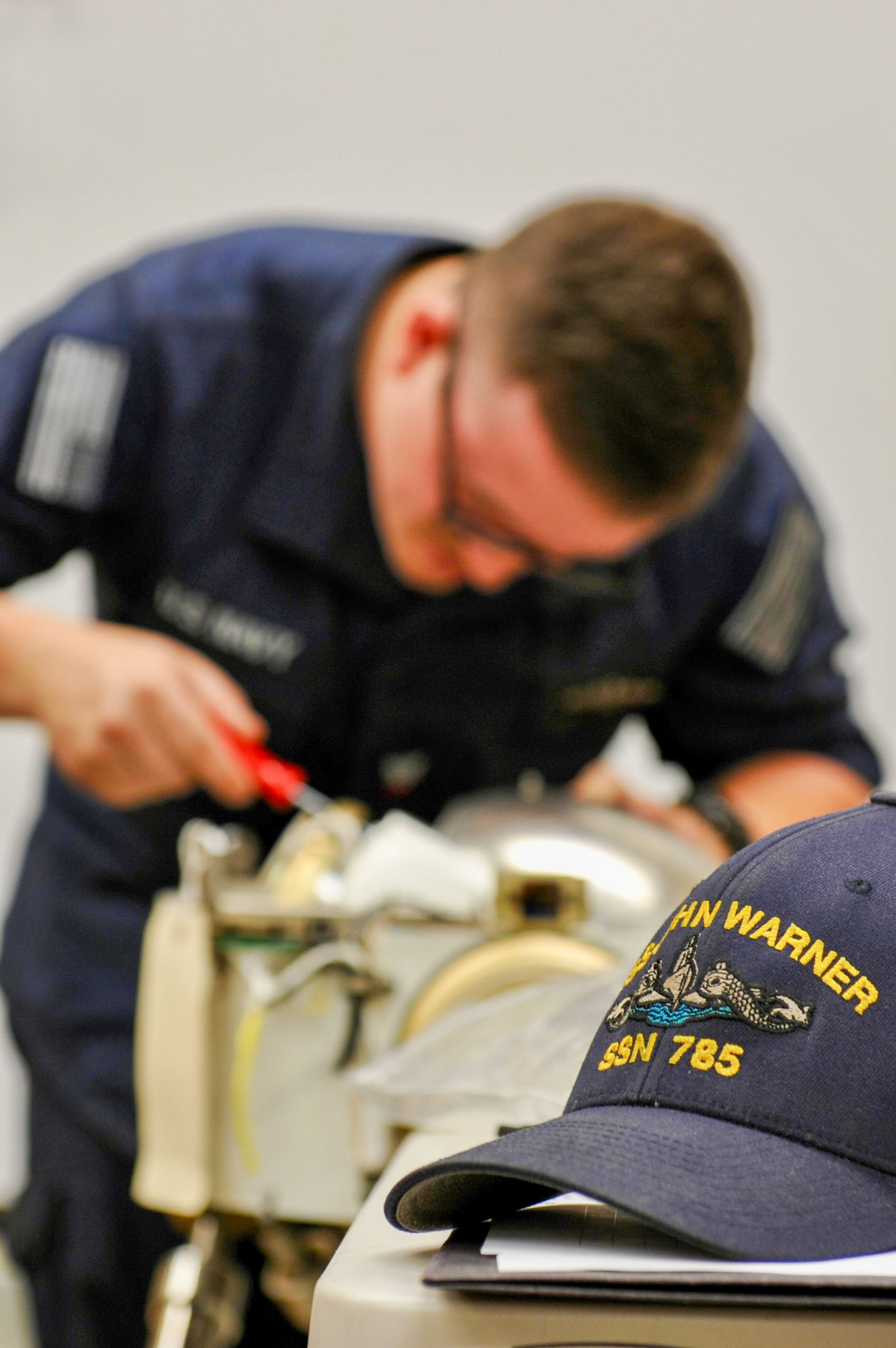 Electronics Technician (Navigation) 2nd Class Patrick Powers starts to take apart a gyro compass as part of the training for fast-attack submarines in HR, June 24-28,2024, at the NIWC Atlantic MTL.