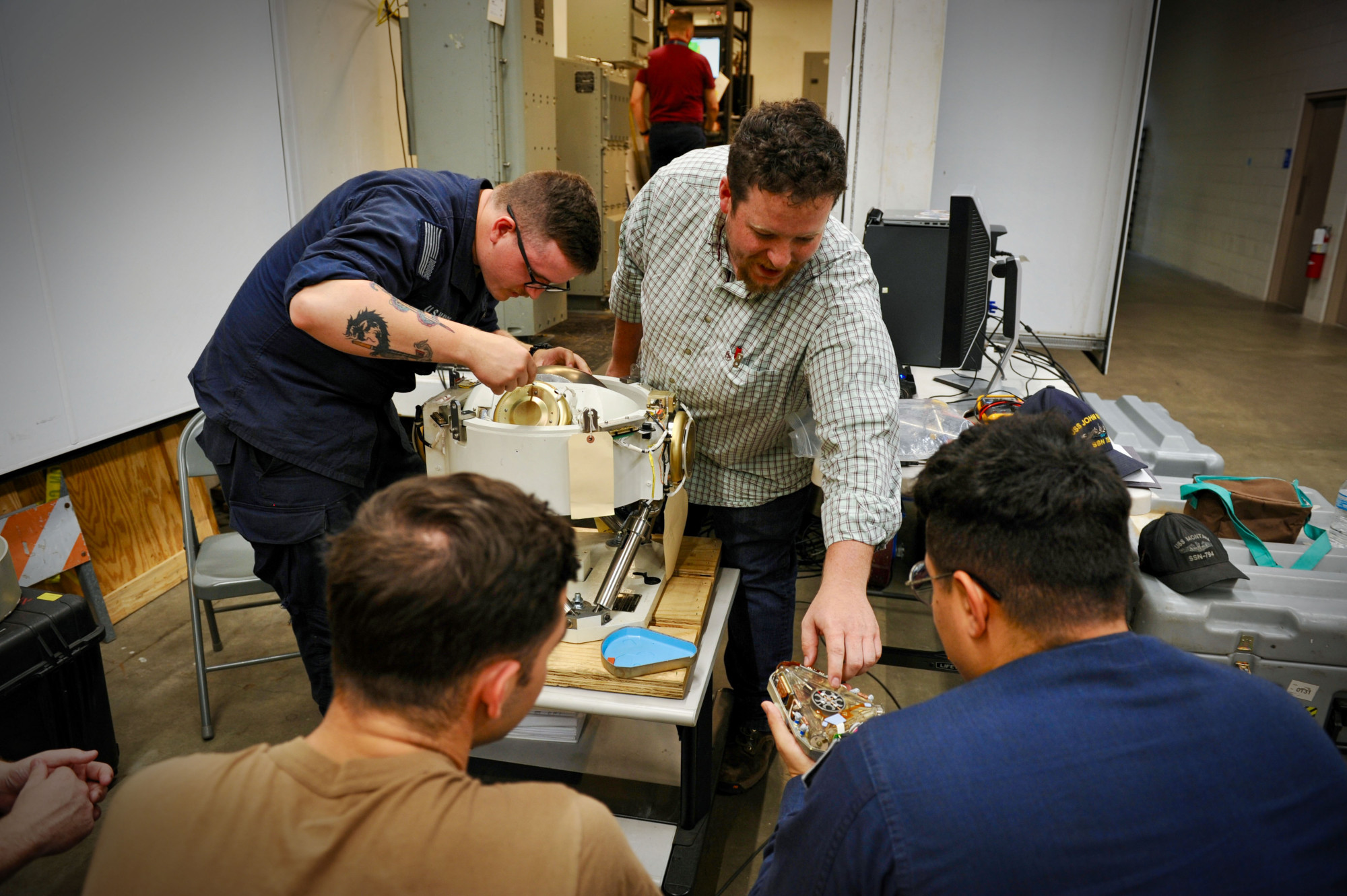 Electronics Technician (Navigation) 2nd Class Patrick Powers starts to take apart a gyro compass as part of the training for fast-attack submarines in HR, June 24-28,2024, at the NIWC Atlantic MTL.