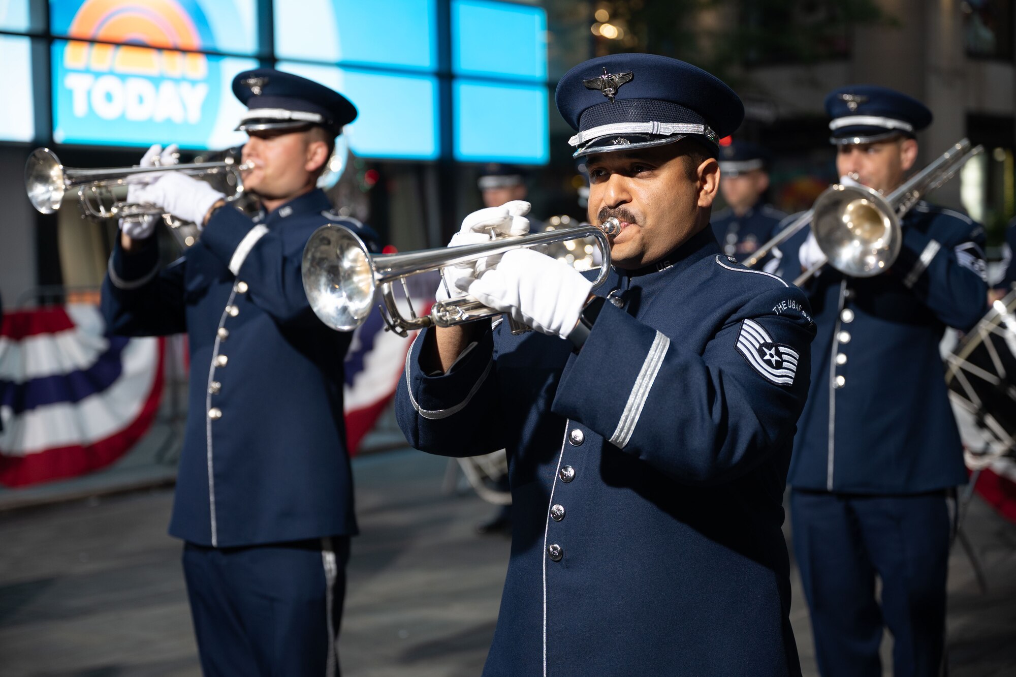 military band members playing brass instruments on plaza