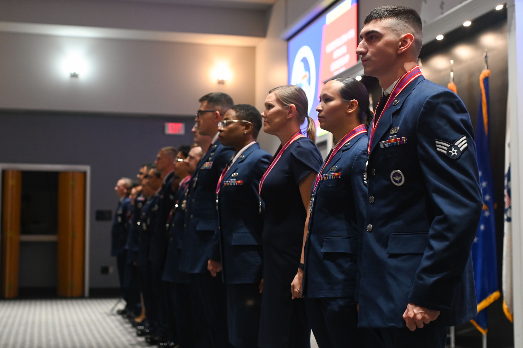 U.S. Air Force Airman Leadership School Class 24-E sing The Air Force Song at the end of their graduation at the Powell Event Center, Goodfellow Air Force Base, Texas, July 11, 2024. The Air Force Song is sung at every ALS class graduation. (U.S. Air Force photo by Airman 1st Class Brian Lummus)