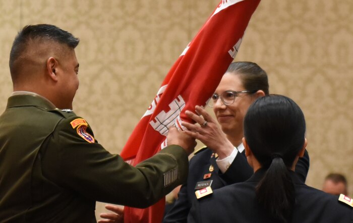 COL Hall passes the Walla Walla District colors to LTC Werback during the Walla Walla District Change of Command ceremony in Walla Walla, WA.