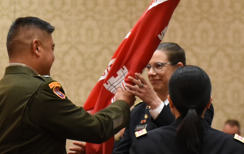COL Hall passes the Walla Walla District colors to LTC Werback during the Walla Walla District Change of Command ceremony in Walla Walla, WA.