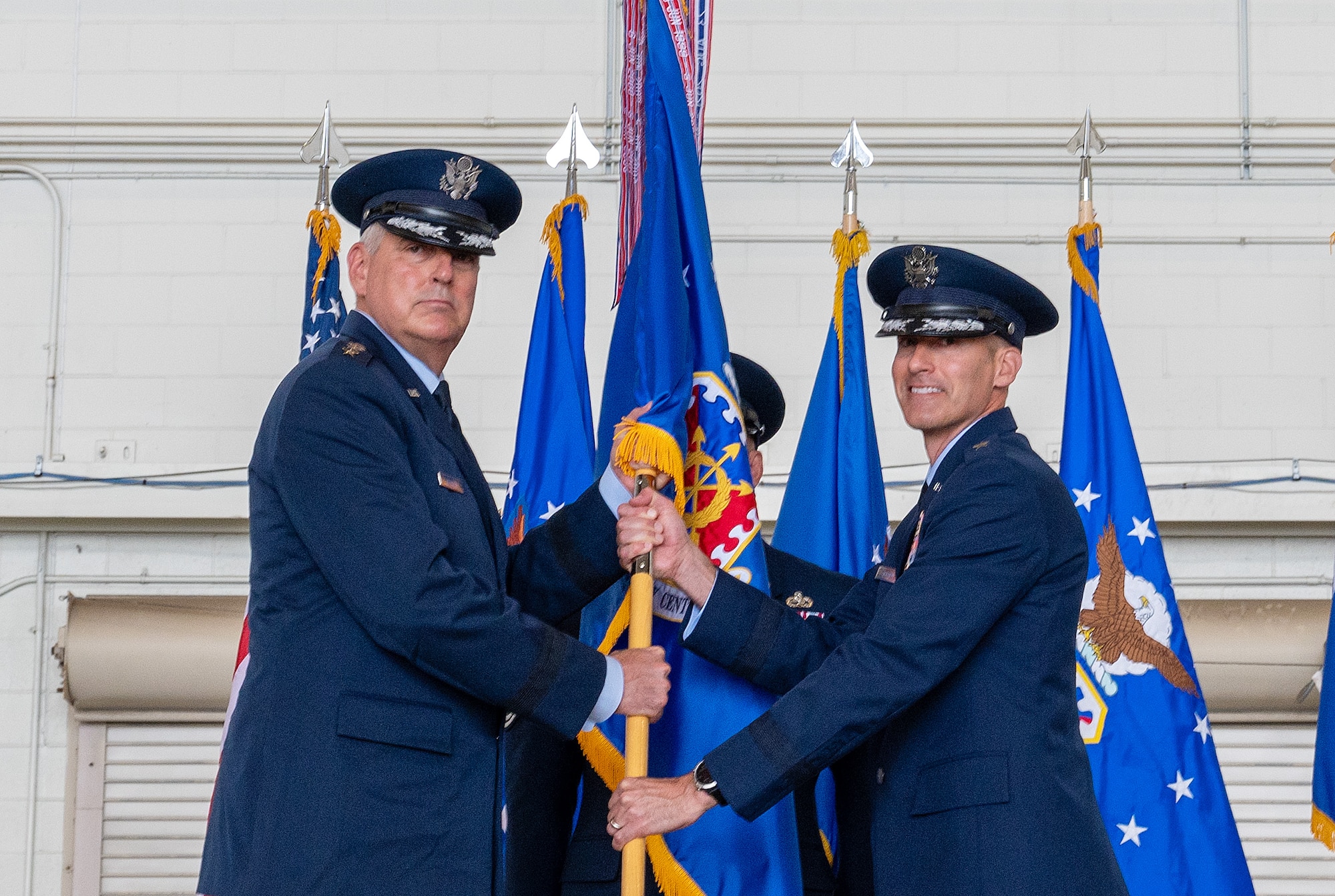 Brigadier Gen. Stephen Snelson accepts the guidon from Gen. Mike Minihan, Air Mobility Command commander, during the Expeditionary Center’s change-of-command ceremony at Joint Base McGuire-Dix-Lakehurst, New Jersey, July 12, 2024.