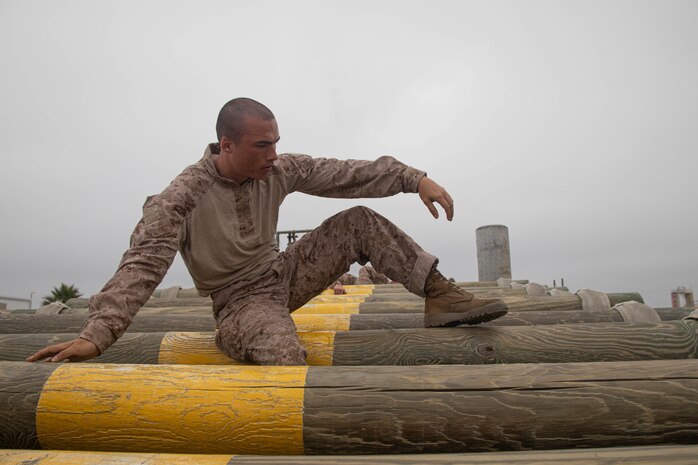 U.S. Marine Corps Recruit Quynn Perez, with Kilo Company, 3rd Recruit Training Battalion, executes an obstacle during a confidence course event at Marine Corps Recruit Depot San Diego, California, July 1, 2024. The confidence course challenged recruits physically and mentally through obstacles that require confidence in their strength, balance, and determination. (U.S. Marine Corps photo by Cpl. Elliott A. Flood-Johnson)