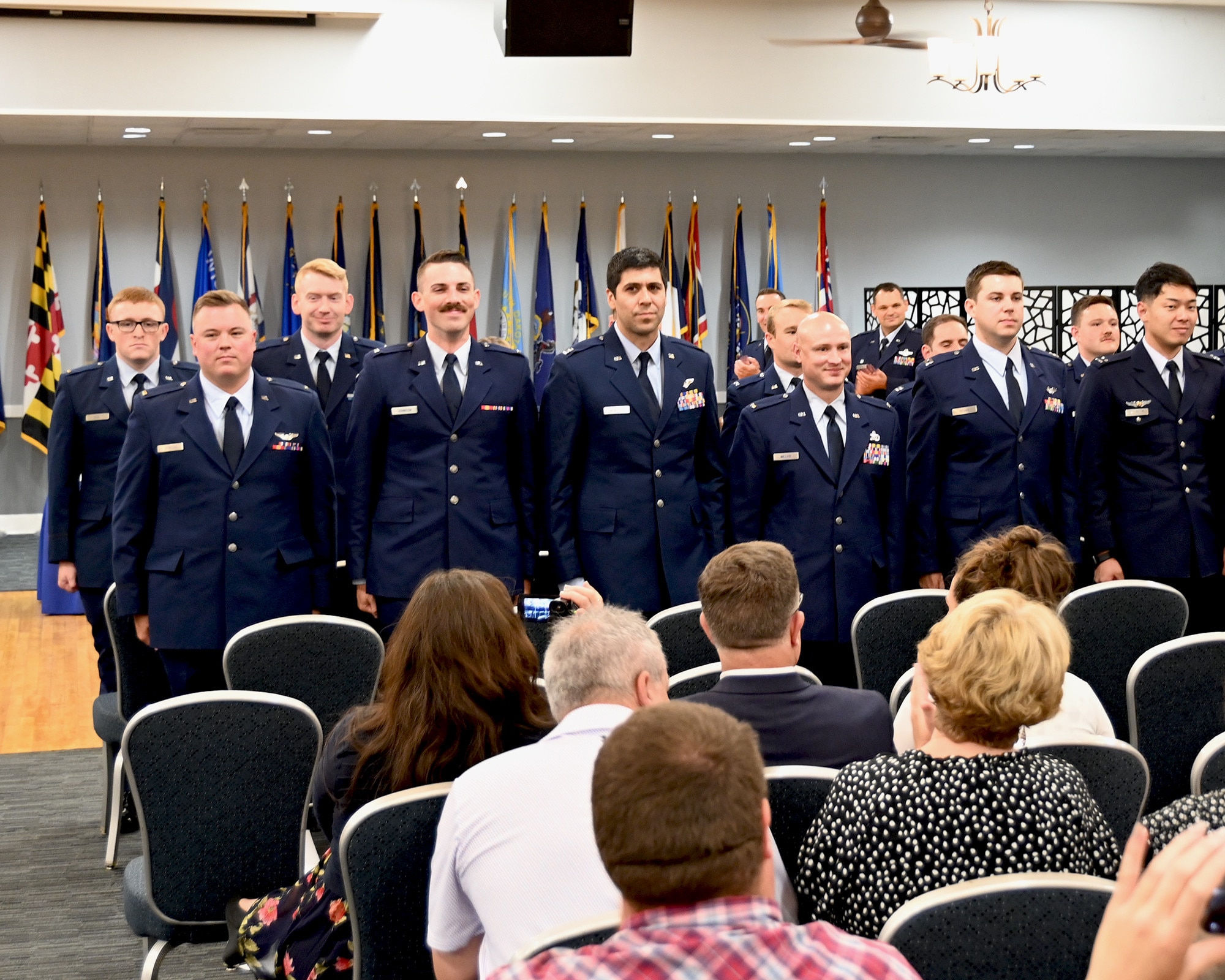 Newly winged pilots standing for the crowd.