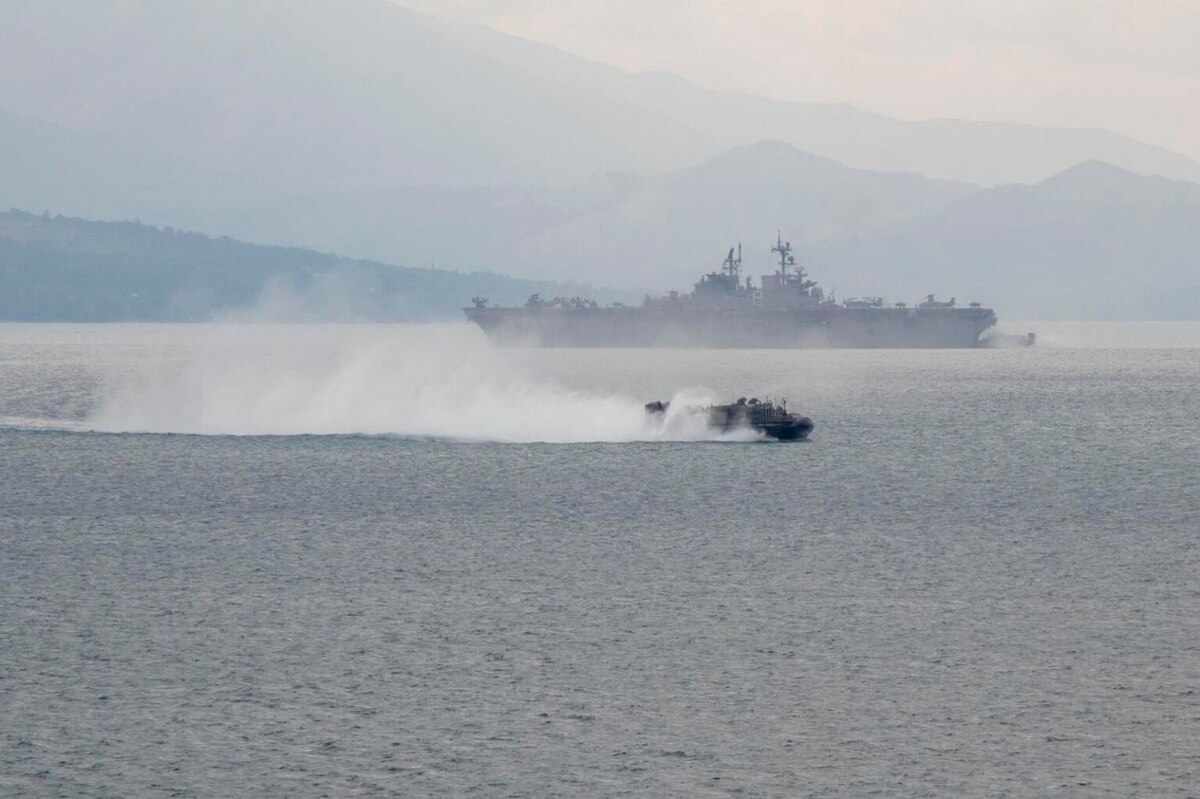 A military vessel transits water.
