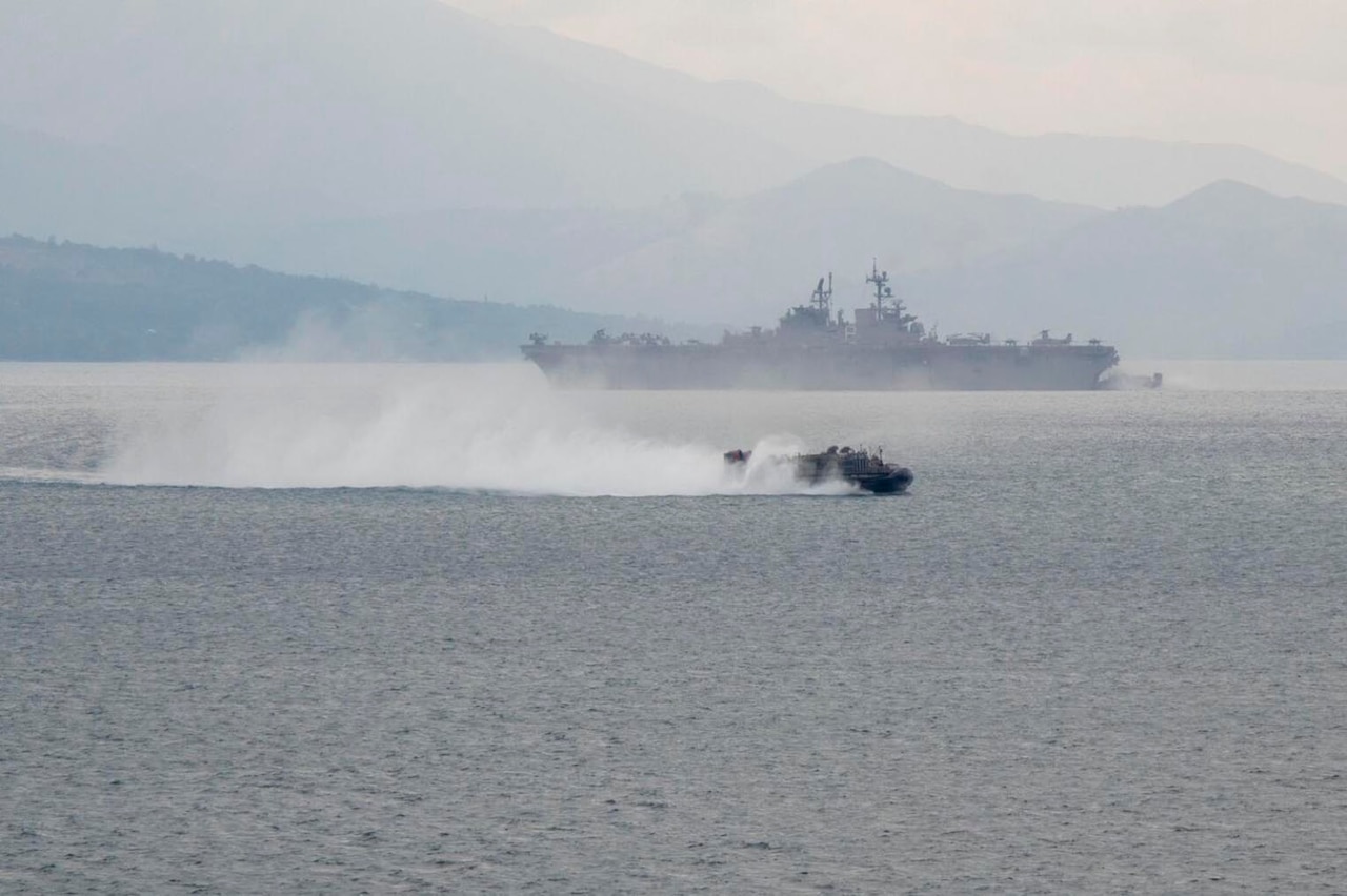 A military vessel transits water.