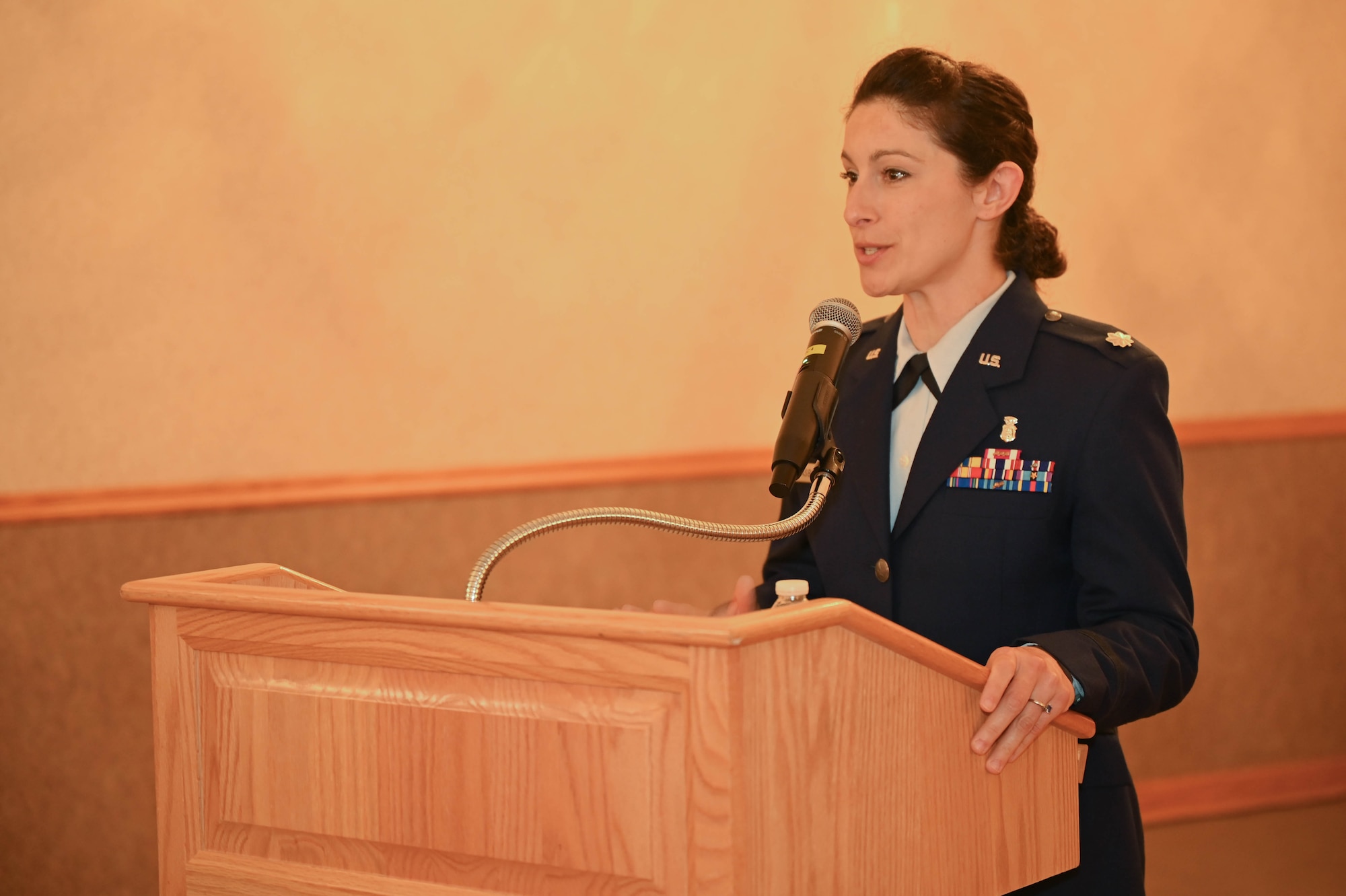 An Airman speaks at a ceremony.