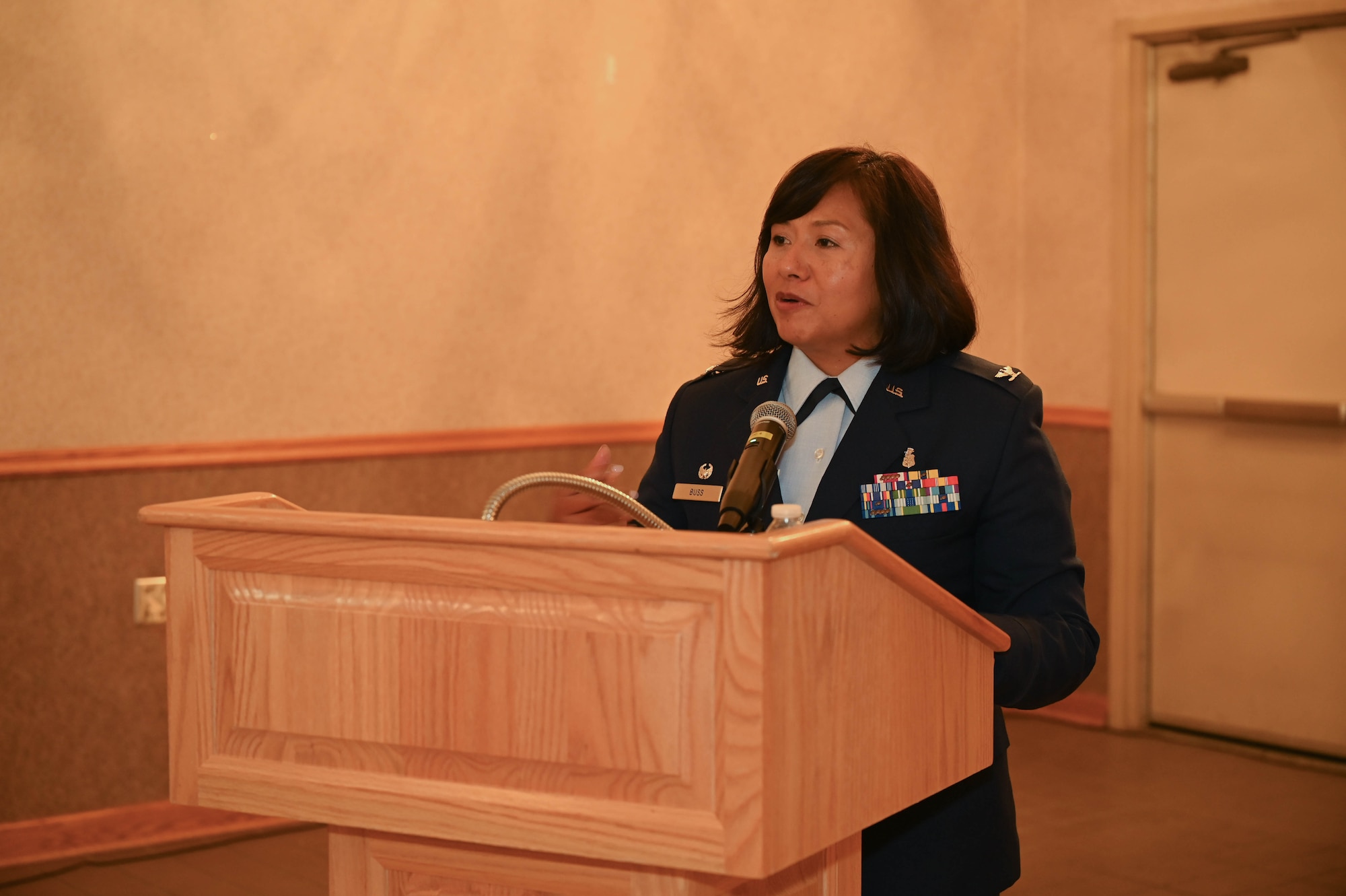 Col. Fara Buss, 354th Medical Group commander, gives a speech during a ceremony.