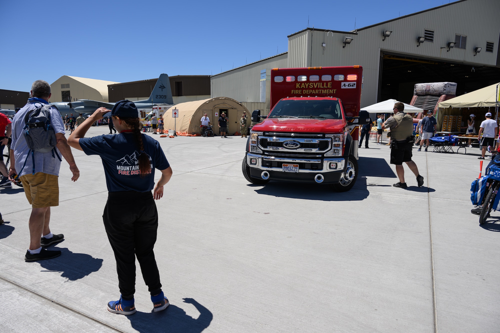 A red ambulance responds to an emergency on the airfield.