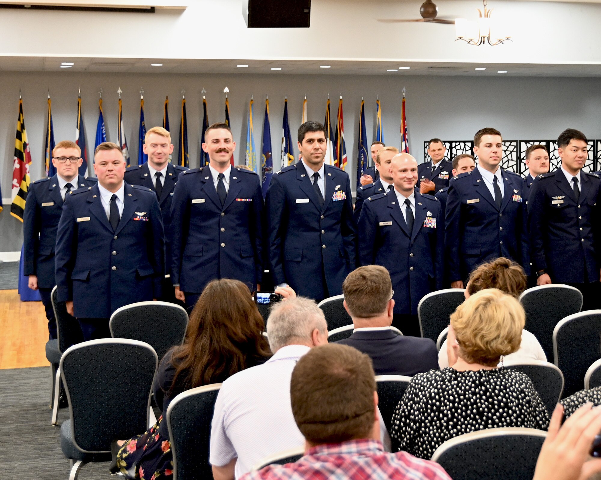 Newly winged pilots standing for the crowd.