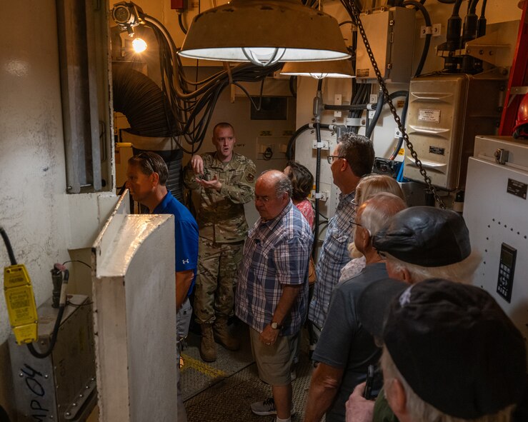 U.S. Air Force Staff Sgt. Seth Mihalak, 373rd Training Squadron operations flight chief, provides a tour of a missile launch training facility to military retirees during Retiree Appreciation Day at Minot Air Force Base, North Dakota, July 12, 2024. The tour allowed the military retirees to see what a modern-day missile launch facility looks like. (U.S. Air Force photo by Senior Airman Kyle Wilson)