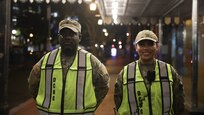 U.S. Army Spc. Sam Banini, motor transport operator, 1229th transportation company, left, and U.S. Air Force Senior Airman Catherine Sarmiento, materiel management specialist with the 113th Logistics Readiness Squadron, right, guard a traffic control point within the District in Washington D.C. on July 9, 2024. Members of the District of Columbia and Maryland National Guard supported Metropolitan police during the 75th anniversary of the NATO alliance.