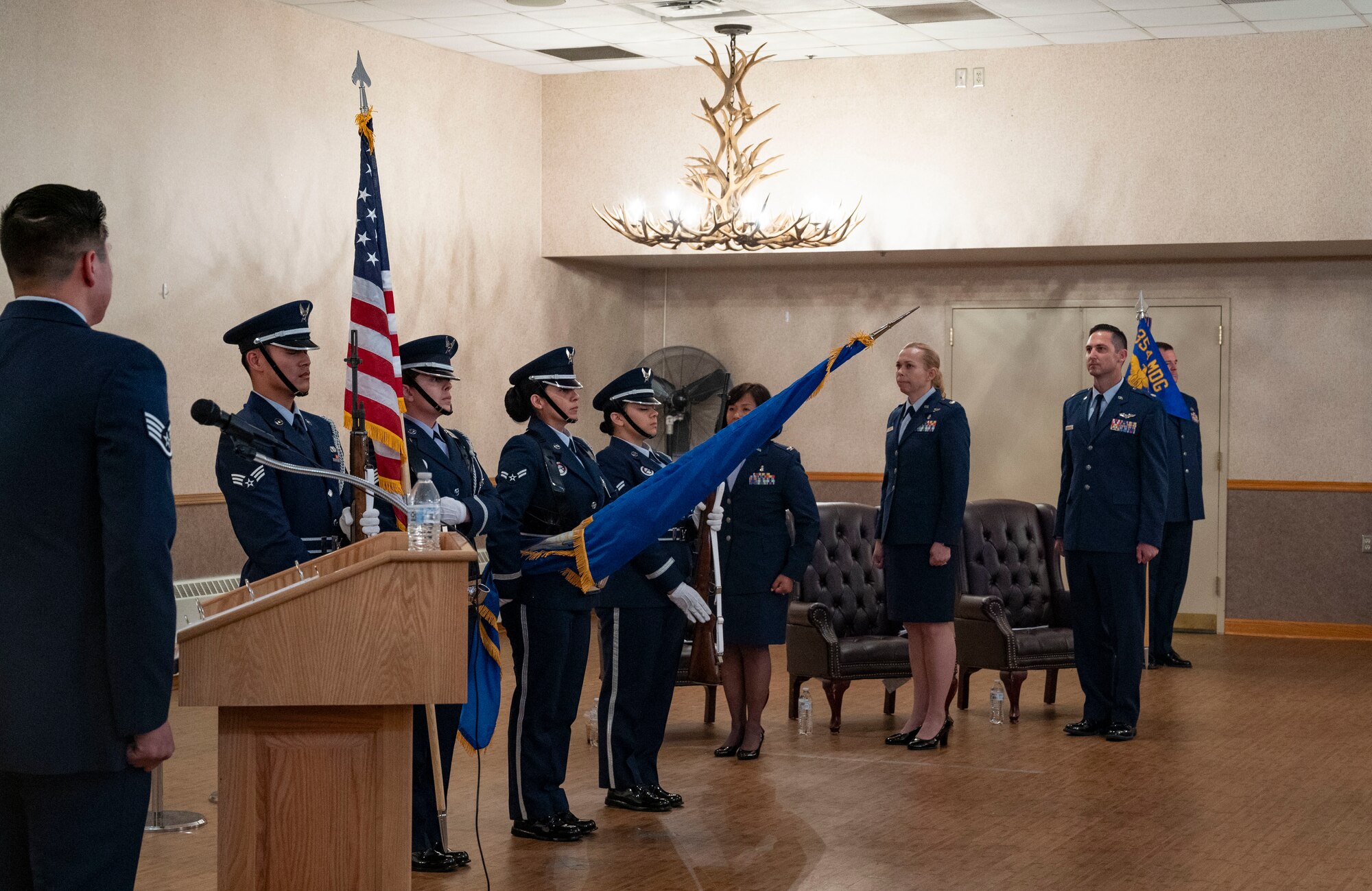 Airmen assigned to the 354th Honor Guard conduct a flag ceremony during the 354th Operational Medical Readiness Squadron Change of Command ceremony.
