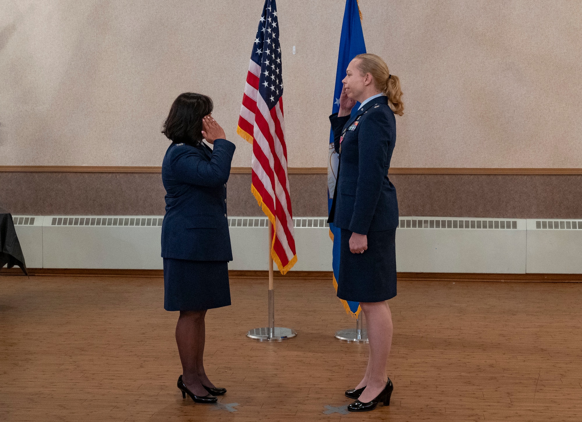 U.S. Air Force Col. Farrah Buss, 354th Medical Group commander, and Lt. Col. Chelsea Payne, 354th Operational Medical Readiness Squadron outgoing commander, salutes each other during a Change of Command ceremony.