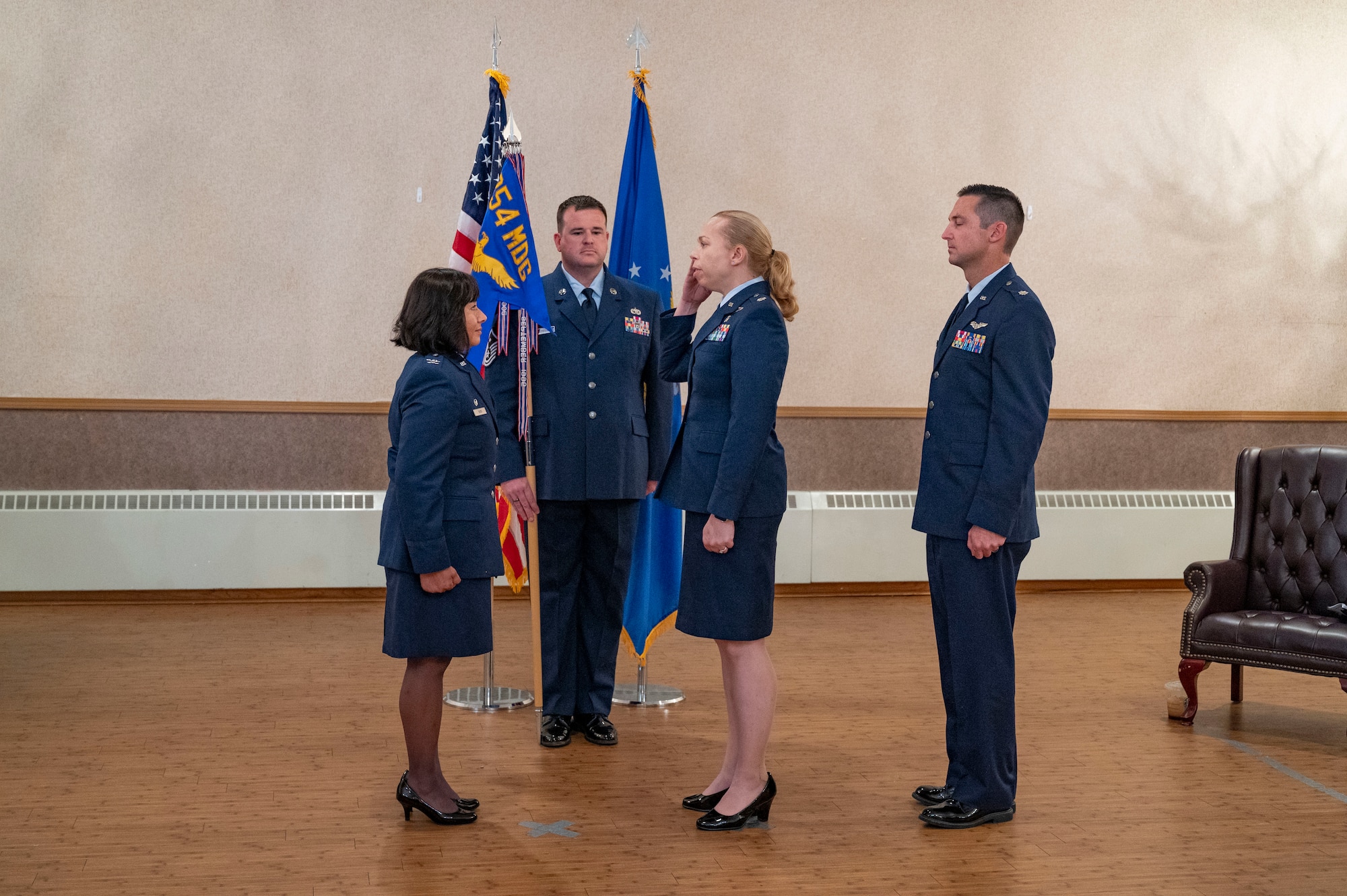 U.S. Air Force Col. Farrah Buss, 354th Medical Group commander, receives guidon from Lt. Col. Chelsea Payne.