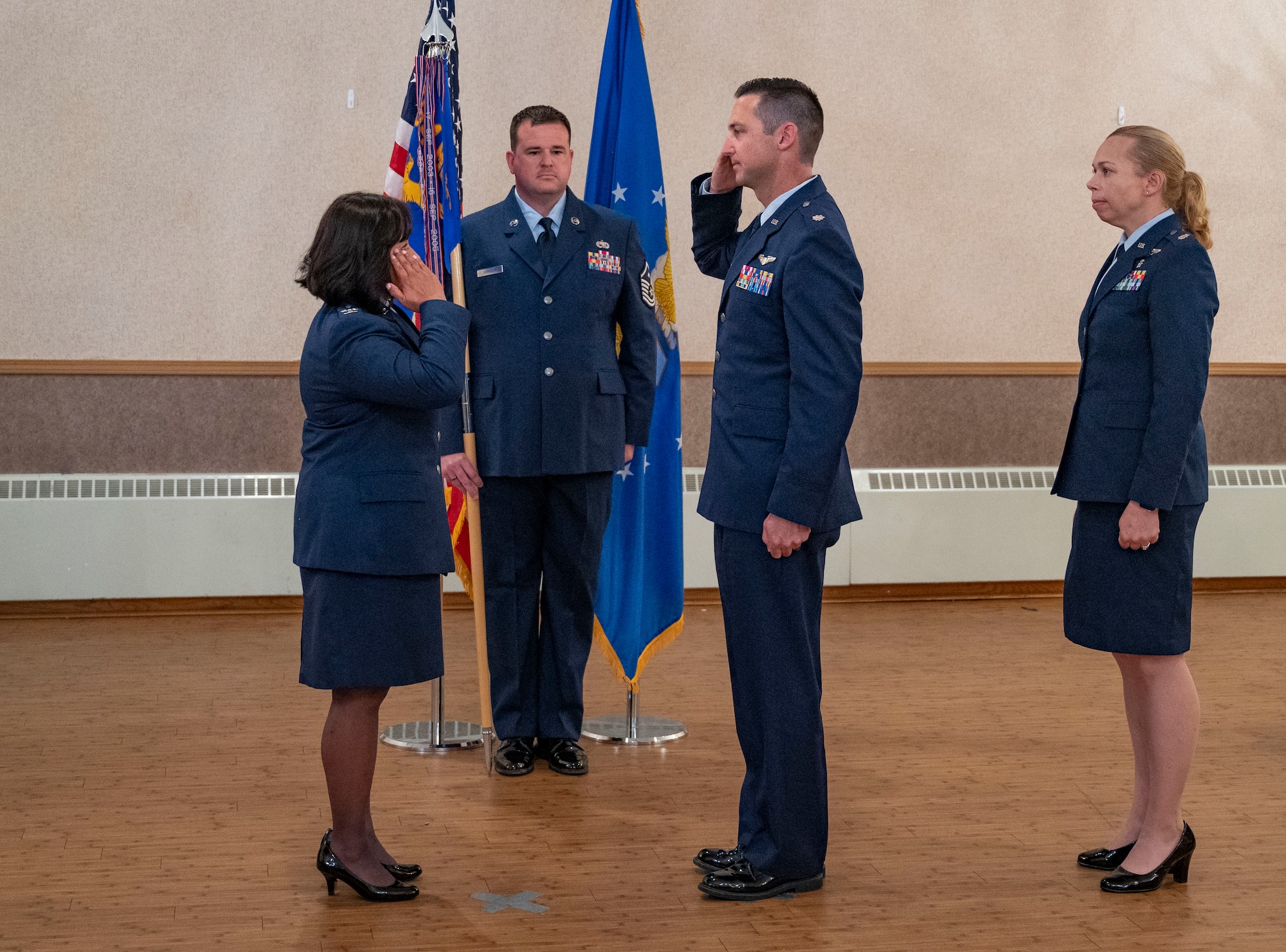 U.S. Air Force Lt. Col. John Olshefski, 354th Operational Medical Readiness Squadron commander, renders a salute to Col. Farrah Buss.