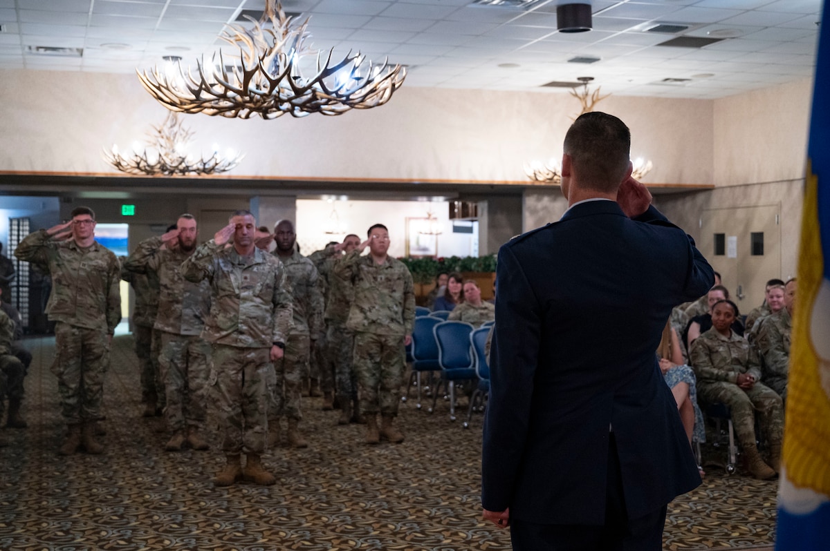 Lt. Col. John Olshefski, 354th Operational Medical Readiness Squadron commander, salutes Airmen from the 354th OMRS during a ceremony.