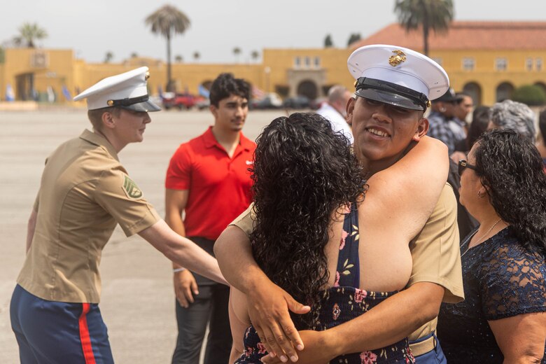 U.S. Marine Corps Pvt. Carlos Paz-Sosa, a Marine with India Company, 3rd Recruit Training Battalion, greets a guest following a graduation ceremony at Marine Corps Recruit Depot San Diego, California, July 12, 2024. Paz-Sosa was highlighted due to his impressive transformation, losing more than 100 lbs. in order to become a Marine. (U.S. Marine Corps photo by Cpl. Elliott A. Flood-Johnson)
