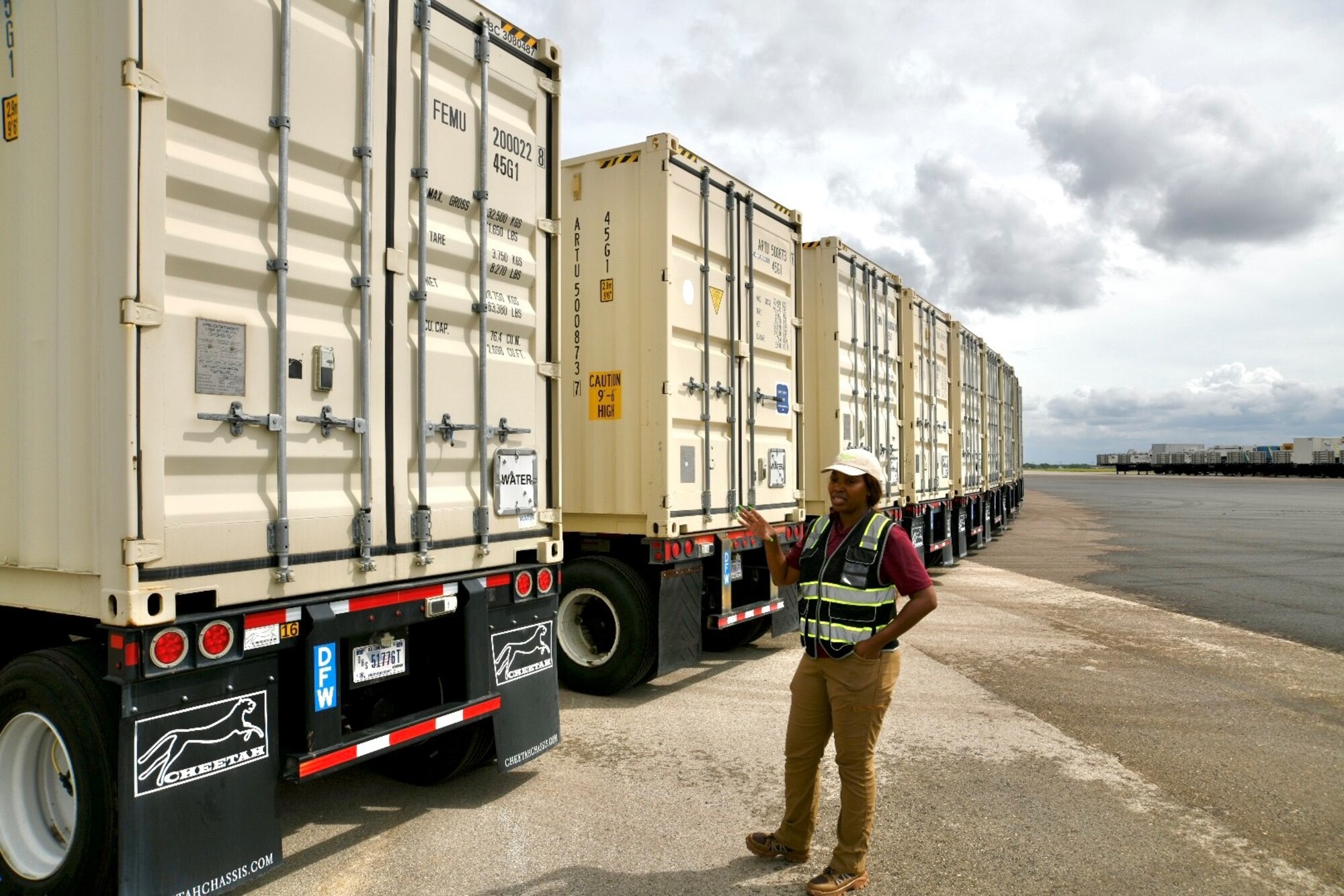 FEMA employee gesturing toward trailer labeled "Water"